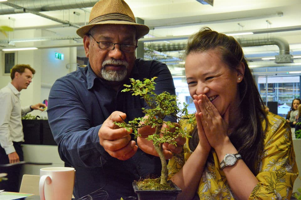 Participants learning bonsai during a corporate workshop